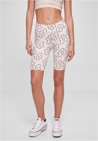 Bermuda shorts made of stretchy, lightweight fabric in light pink with black floral patterns. Features a high waistband and a fitted cut.