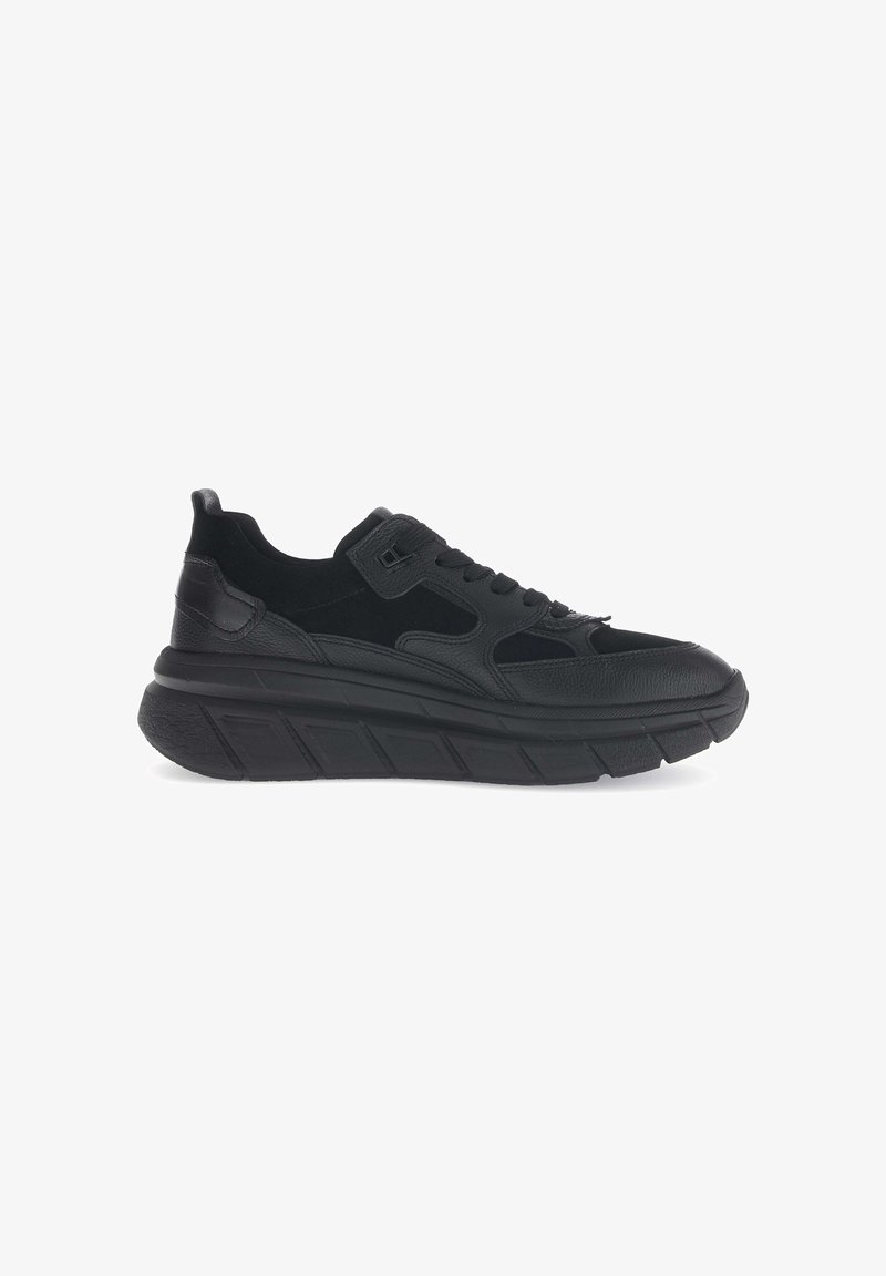 Black sneakers with a combination of leather and suede upper, thick textured sole, rounded toe, and subtle accents in the design.