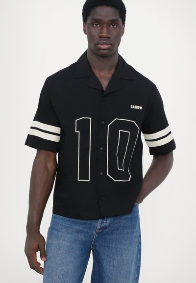 Black short-sleeve shirt featuring white graphics with a large "10" on the front and stripes on the sleeves, with a button-down design.