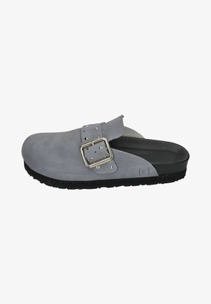 Gray suede clog with a wide strap and silver buckle detail. Black textured sole; slip-on design for easy wear. Smooth inner lining.