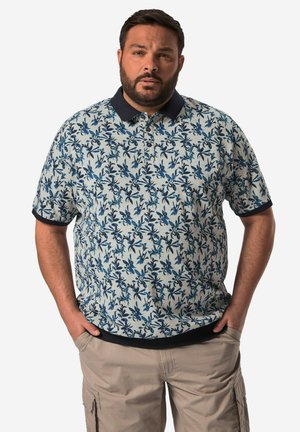 Kortærmet polo i lyseblå med mørkeblå blomstermønster, med en mørkeblå krave og ribbede manchetter. Casual-fit design.