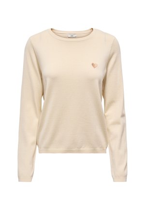 Maglione color crema a maniche lunghe con un piccolo cuore ricamato sul petto sinistro e scollo rotondo.