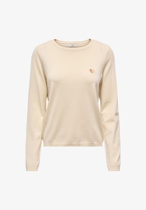 Maglione color crema a maniche lunghe con un piccolo cuore ricamato sul petto sinistro e scollo rotondo.
