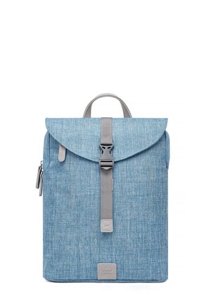 Blue fabric backpack with a flap closure, gray strap, and top handle. Features a logo patch and a side zipper pocket. Textured surface.