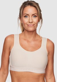 Beige sportbh met brede bandjes, een gemêleerd voorpaneel en zachte stof. Voorzien van logo op de onderrand en een naadloos ontwerp voor comfort.