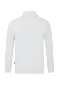 Polo à manches longues blanc avec un col montant, présentant une texture lisse et un ourlet droit. Pas de motifs ni d'accents visibles.