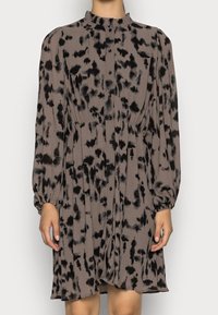 Brown and black spotted dress with high neckline, long puff sleeves, buttons down the front, and gathered waist detail. Soft, textured fabric.