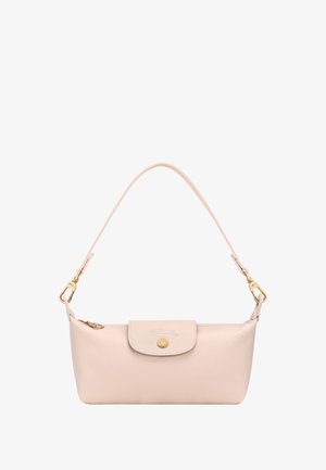 Small pale pink leather handbag with single strap, flap closure, gold button, and gold hardware on white background.