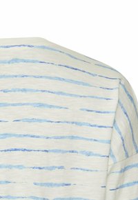 Lichte katoenen top met horizontale blauwe strepen op een crèmekleurige achtergrond. Zachte textuur met een relaxte pasvorm en ronde halslijn.