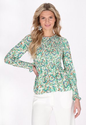 Blomstret peplum bluse i lys grøn, med smocked bodice, lange ærmer med volangmanchetter og flerfarvet paisley mønster.