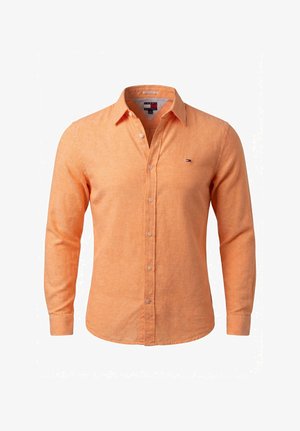 Camisa de hombre de manga larga con botones en color naranja claro, con cuello puntiagudo y pequeño logo en el pecho izquierdo.