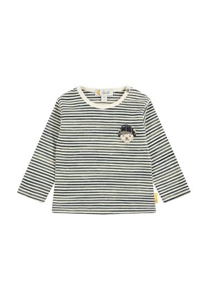 Striped long-sleeve shirt in cream and navy blue cotton. Features a round neckline and a small embroidered patch of a bear with a cap.