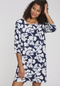 Abito tunica floreale in blu navy con motivi di peonie bianche, maniche a 3/4, scollo rotondo e morbido tessuto di cotone. Vestibilità casual, lunghezza a metà coscia.