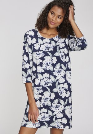 Blumiges Tunika-Kleid in Marineblau mit weißen Pfingstrosenmuster, 3/4-Ärmel, Rundhalsausschnitt und weichem Baumwollstoff. Lässige Passform, bis zur Mitte des Oberschenkels.