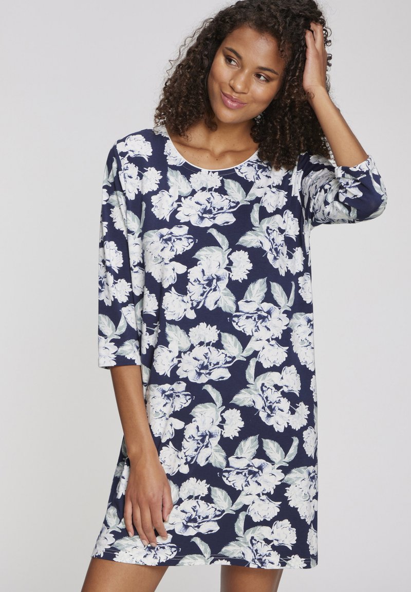 Abito tunica floreale in blu navy con motivi di peonie bianche, maniche a 3/4, scollo rotondo e morbido tessuto di cotone. Vestibilità casual, lunghezza a metà coscia.