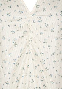 Floral blouse featuring a V-neck, cream fabric with light blue flowers, and subtle vertical stripes. Gathered detail at the center.