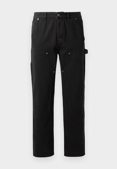 Black cotton pants with a straight leg design, two front pockets, side utility pocket, and snap-button details.