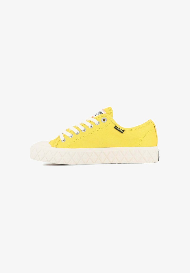 Yellow canvas sneakers with white laces and rubber soles, featuring a textured diamond pattern on the sole and branding on the side.