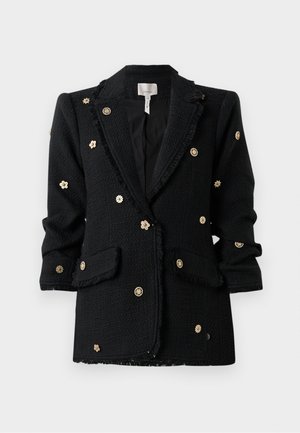 Schwarzer Blazer aus strukturiertem Stoff, mit goldenen Blumenstickereien und fransigen Kanten, zwei vorderen Taschen und einem klassischen Reversdesign.