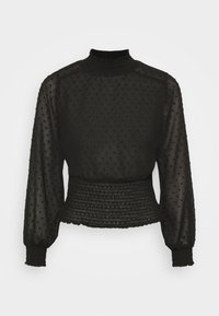 Blusa nera in tessuto trasparente con motivo a pois testurizzato, colletto alto e vita arricciata. Presenta maniche lunghe e puffate.