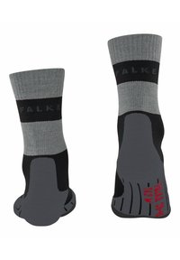 Calzini grigi e neri con rinforzo sul tallone e sulla punta, marchio FALKE sulla fascia e suole testurizzate per una maggiore aderenza.