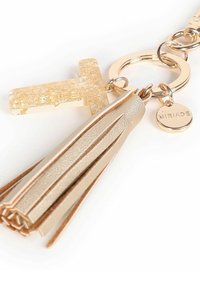 Portachiavi oro con ciondolo a forma di T trasparente glitterato oro, nappa in pelle e un piccolo disco circolare inciso con la parola "MIRIADE."