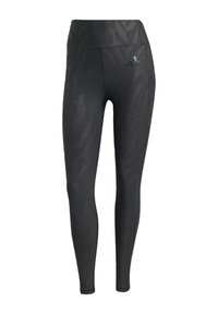 Schwarze Leggings mit einem tonalen Zebra-Muster, hoher Taille, glatter Textur und einem Adidas-Logo auf der linken Hüfte. Aus dehnbarem Material hergestellt.