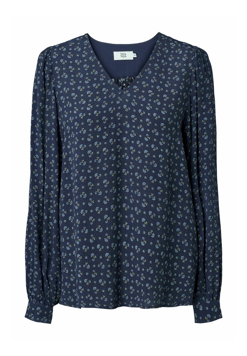 Blusa blu navy con scollo a V, maniche lunghe a sbuffo e piccoli motivi floreali in blu e verde su un tessuto strutturato. Vestibilità ampia.