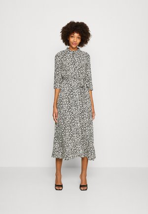 Black and white floral midi dress with a collared neck, three-quarter sleeves, and a cinched waist, featuring a flowing skirt and lightweight fabric.