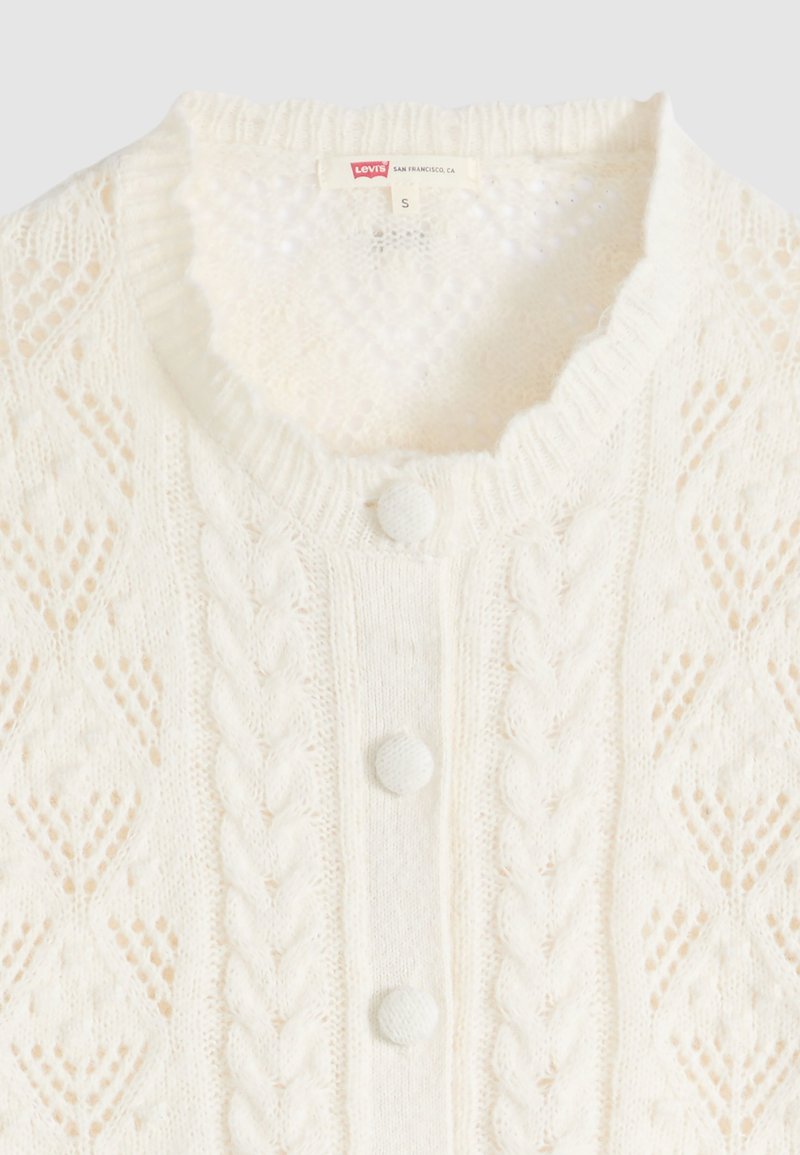 Cream knit cardigan with cable and diamond patterns, round fabric-covered buttons, and ribbed crew neckline, size small by Levi's.