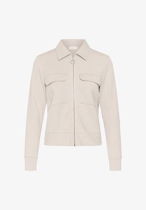 Veste beige à manches longues avec col, fermeture éclair frontale, deux poches poitrine à rabat, coupe ajustée et design minimaliste.