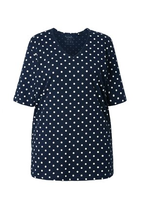 Granatowy top z krótkim rękawem, z dekoltem w serek, wykonany z miękkiego materiału w biały wzór w groszki. Luźny krój z prostym obszyciem.
