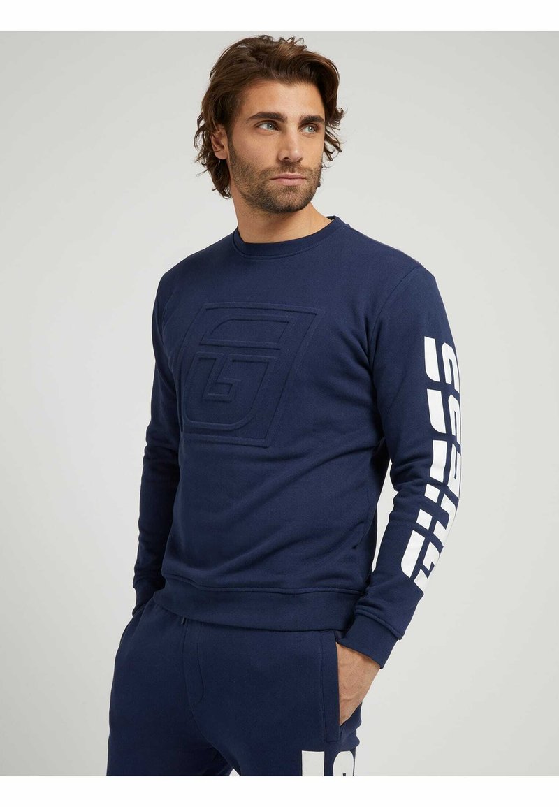 Herren Kapuzenpullover | Guess SEITLICHES LOGO Sweatshirt blau - YJ12272 Herren Kapuzenpullover | Guess SEITLICHES LOGO Sweatshirt blau - YJ12272