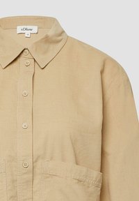Camicia in corduroy beige con colletto, chiusura frontale con bottoni e grandi tasche anteriori, taglia 36, marca s.Oliver.