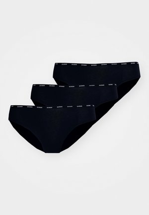 Trois paires de sous-vêtements noirs avec une texture lisse et une ceinture élastique étroite arborant le logo "GUESS" en blanc.