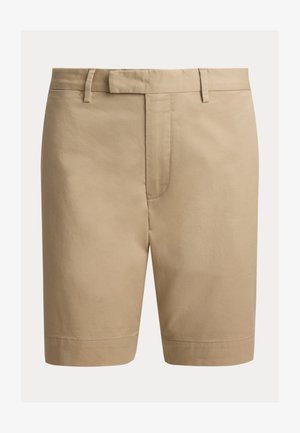 Pantaloncini beige su misura fino al ginocchio con passanti per cintura e chiusura frontale, esposti su uno sfondo bianco semplice.