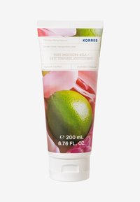 Tube de lait hydratant pour le corps KORRES, arborant un motif de lime verte, des accents de fleurs roses, un capuchon blanc et des étiquettes claires. Capacité de 200 mL.