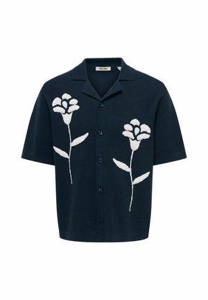 Chemise bleu marine à manches courtes boutonnée avec col, présentant deux grands motifs floraux blancs à l'avant.