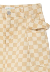Beige and cream checkered pants with a rolled cuff, featuring a button closure and side pocket. Made from a durable cotton blend fabric.