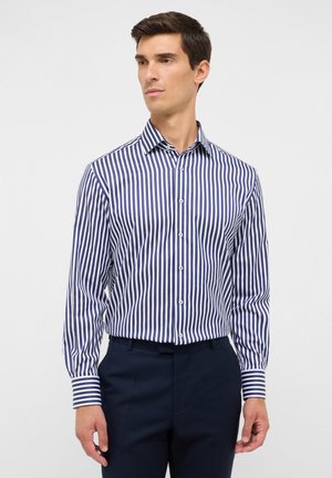 Marineblau-weiß gestreifte Hemdbluse mit Kragen, langen Ärmeln und knöpfbaren Manschetten, aus einem glatten Stoff gefertigt. Figurbetonter Schnitt.