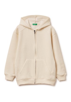 Lichtbeige zip-up hoodie gemaakt van zachte stof. Het heeft een grote capuchon, twee voorkeurszakken, ribbels aan de mouwen en een gladde ritssluiting.