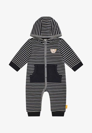 Combinaison à rayures avec capuche en bleu marine et blanc, ornée d'un patch d'ours, de deux poches avant et de poignets côtelés pour un ajustement confortable. Matière en coton doux.