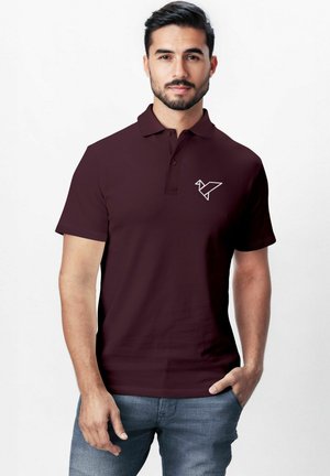 Burgundy polo shirt with short sleeves, classic collar, and a white origami bird logo on the left chest, made from smooth fabric.