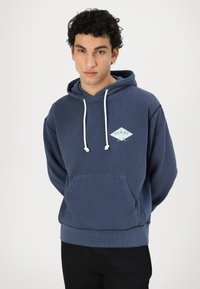 Felpa con cappuccio in cotone blu navy, con logo a diamante, cordini bianchi e tasca a marsupio. Polsini e orlo a coste con una vestibilità rilassata.