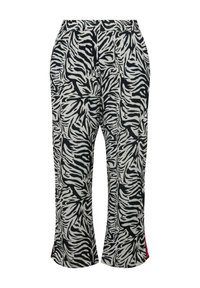 Zwart-wit zebraafdruk broek met een ontspannen pasvorm, elastische tailleband en zijsplitten die rode accenten bij de zoom onthullen.