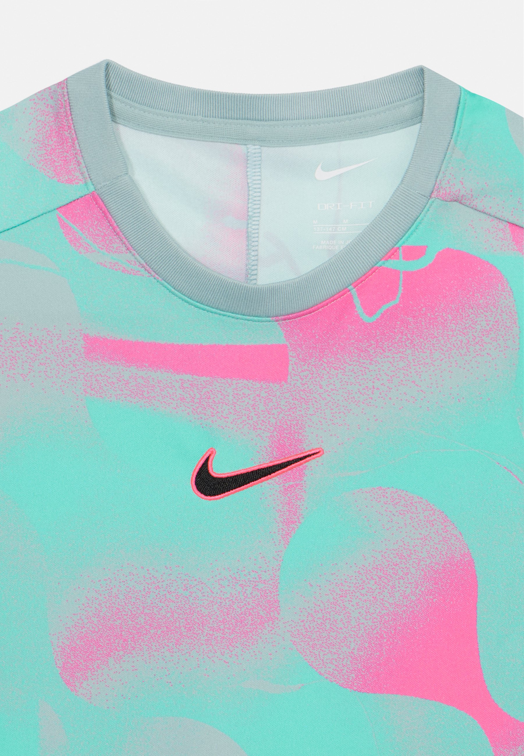 white pink and blue nike shirt