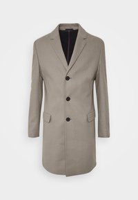 Cappotto in lana beige con un design sartoriale, monopetto, tre bottoni, revers a punta e due tasche frontali. L'interno presenta una fodera a contrasto.