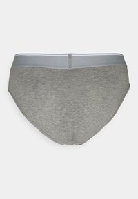Grå bomuldsunderbukser med en glat tekstur, der har en lysegrå elastisk talje og et enkelt design, set fra siden.