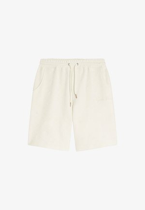 Crèmekleurige shorts met een elastische tailleband, trekkoord, twee zijzakken en een gestructureerd ruitpatroon. Subtiele geborduurde details aan de zijkant.