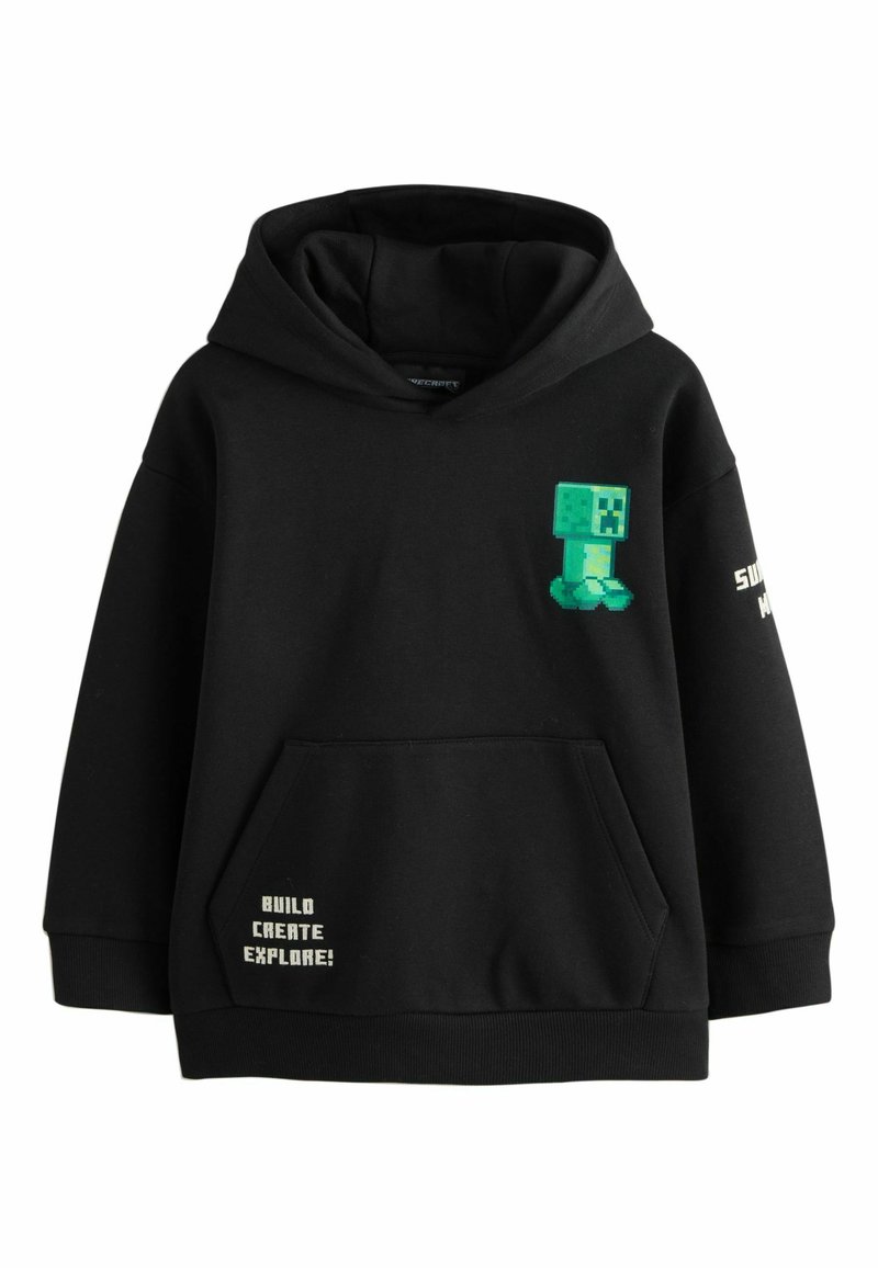 Sudadera negra con un bolsillo frontal, con un diseño de creeper pixelado verde y texto blanco que dice "¡CONSTRUYE, CREA, EXPLORA!" en el lateral.